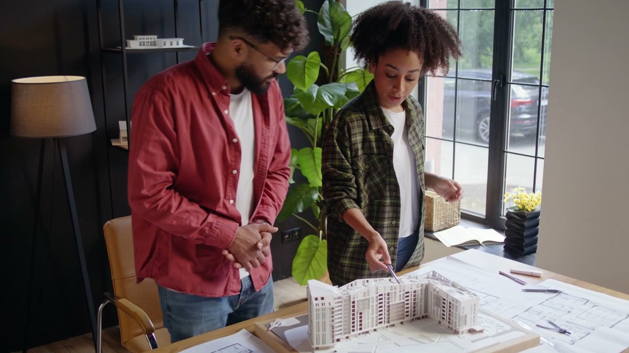 Two Architects Reviewing Building Model