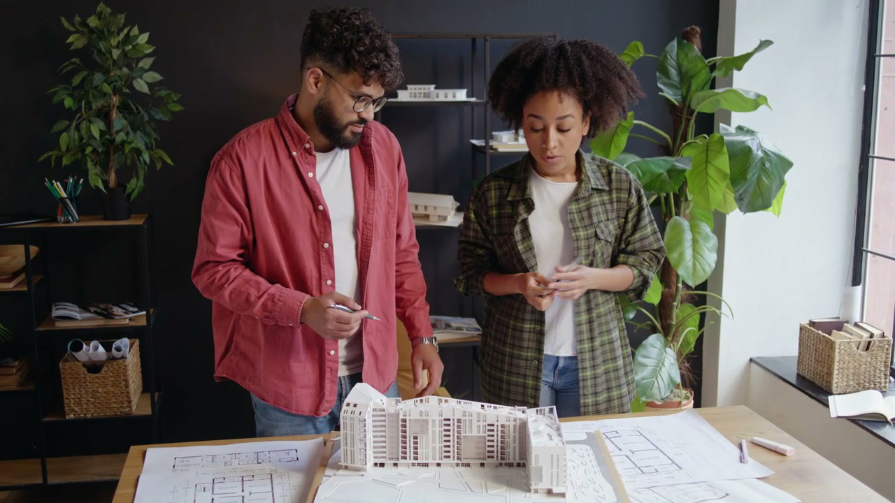 Two Architects Discussing Building Model