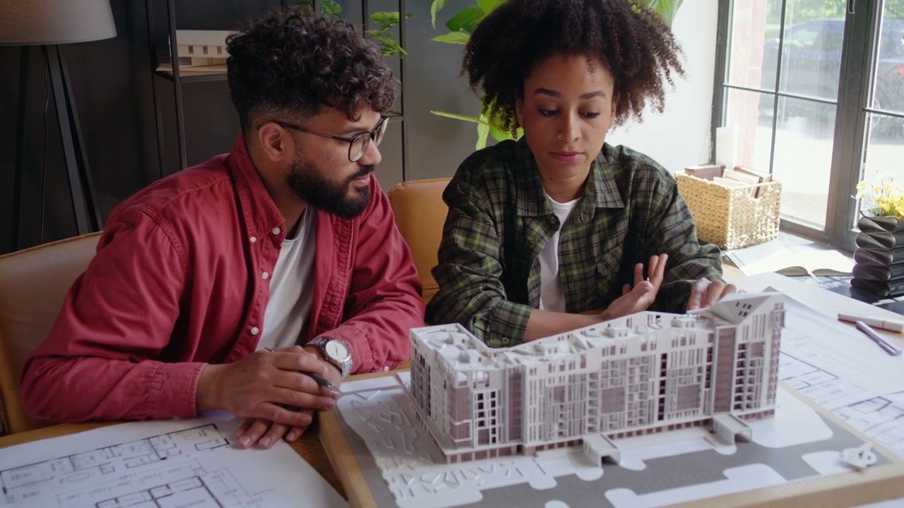 Two Architects Discussing Building Model