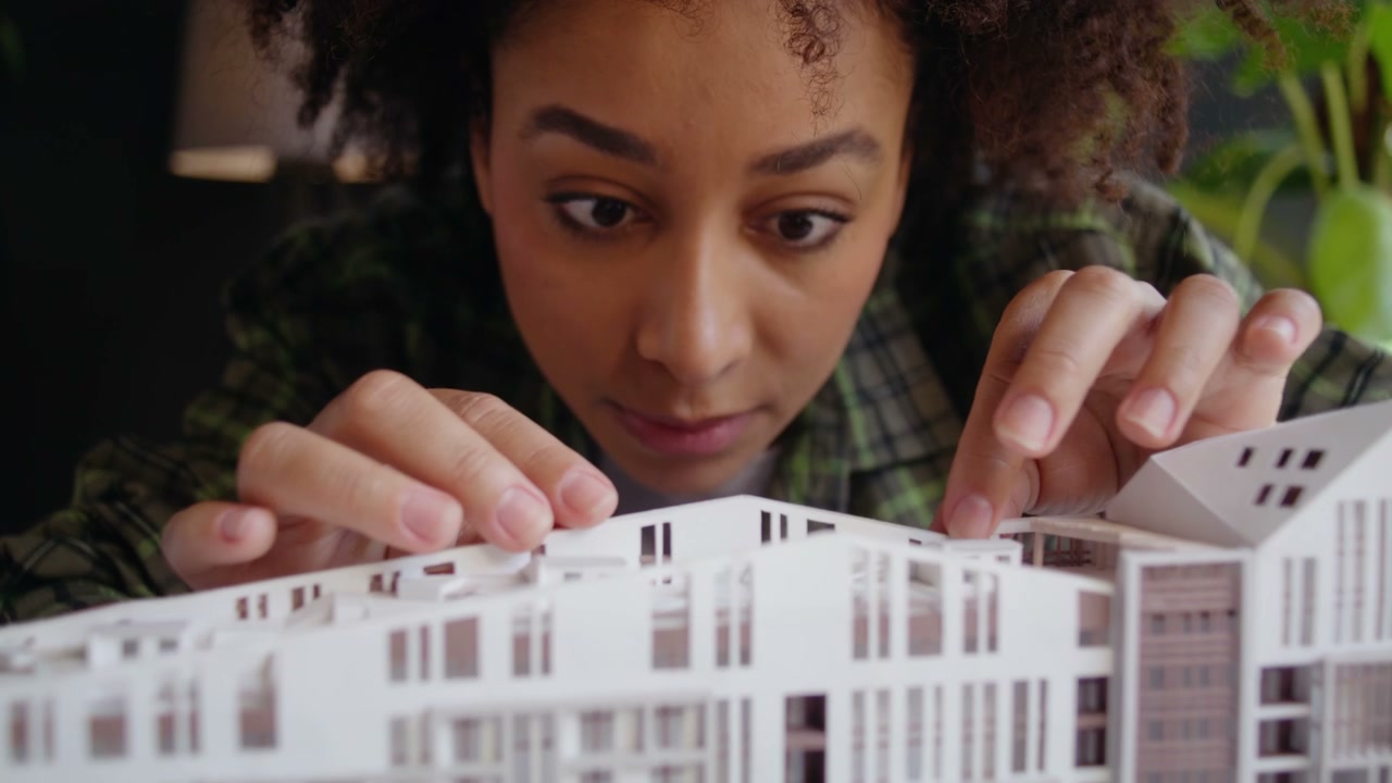 Architect Inspecting Building Model