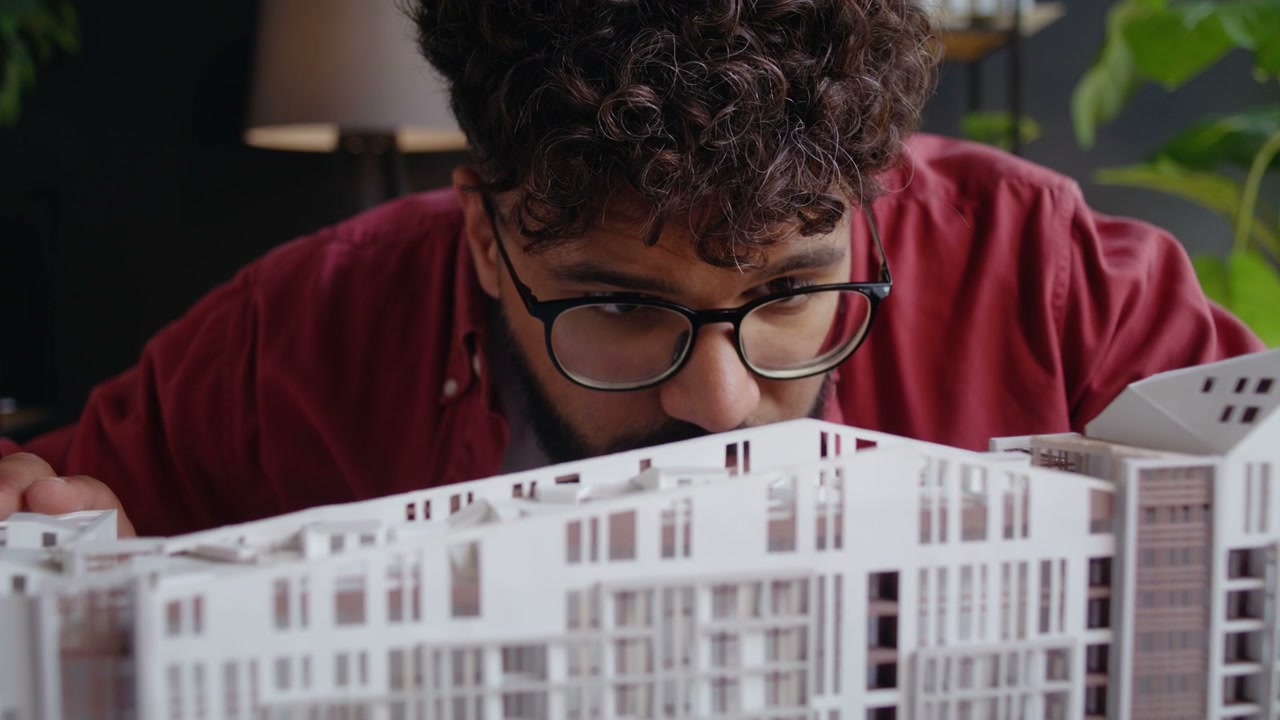 Architect Inspecting Building Model
