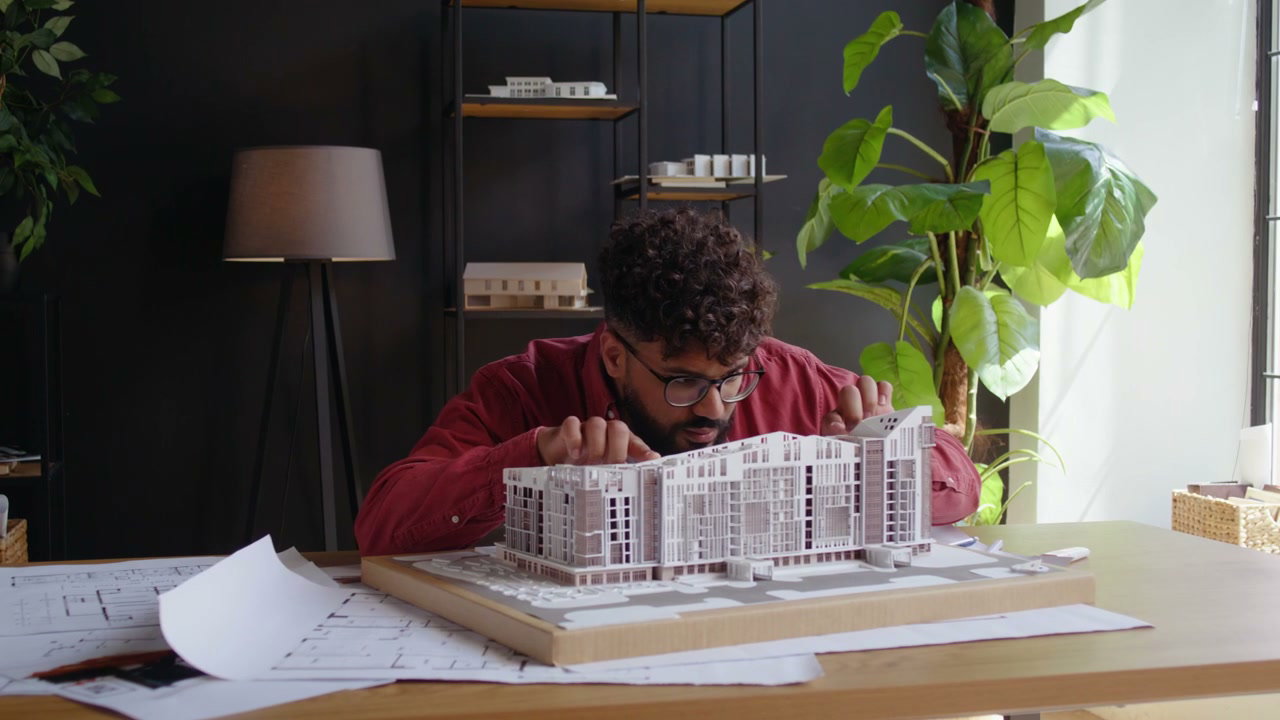 Architect Examining Building Model in Studio