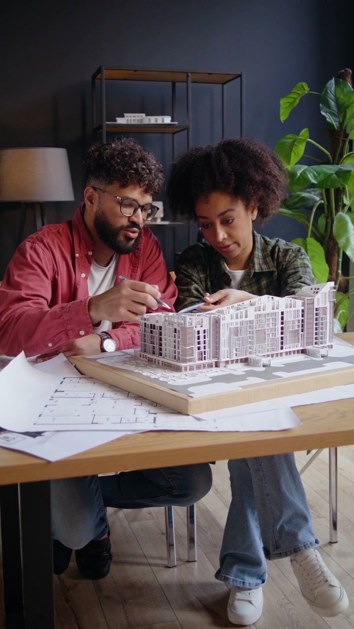 Architects Discussing Building Model in Office