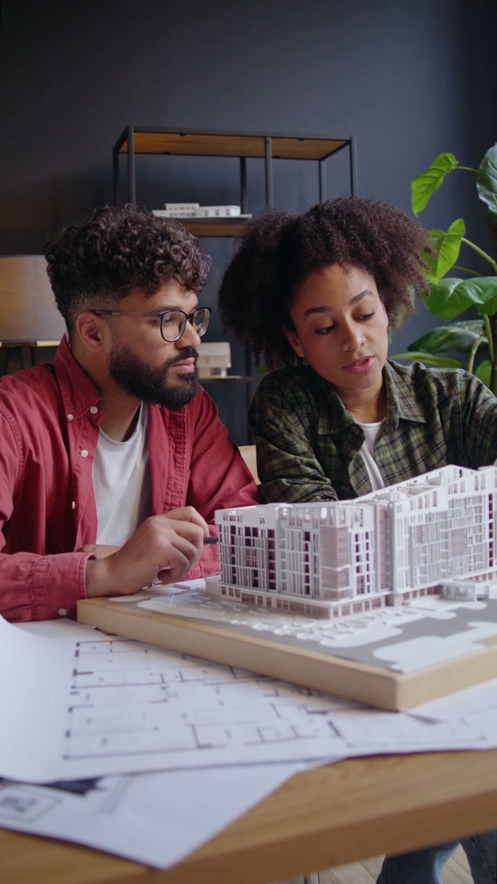 Architects Discussing Building Design in Office