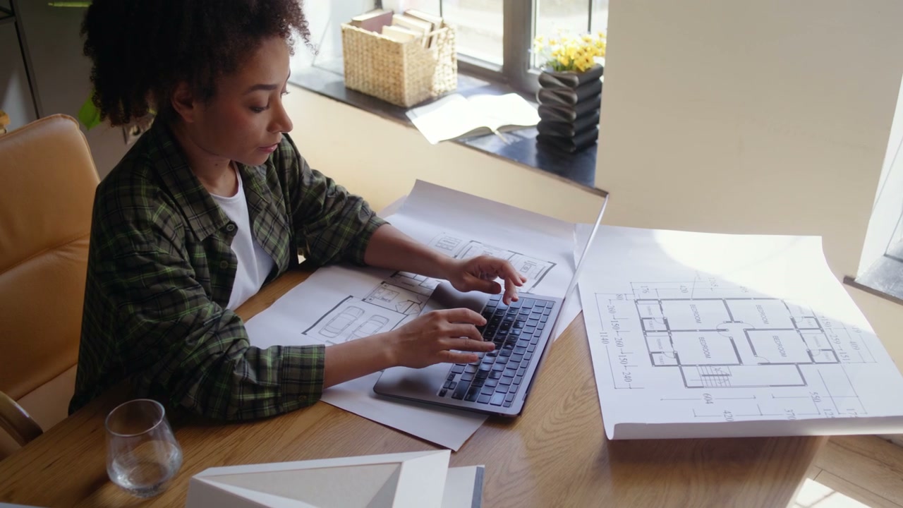 Woman Architect Typing on Laptop