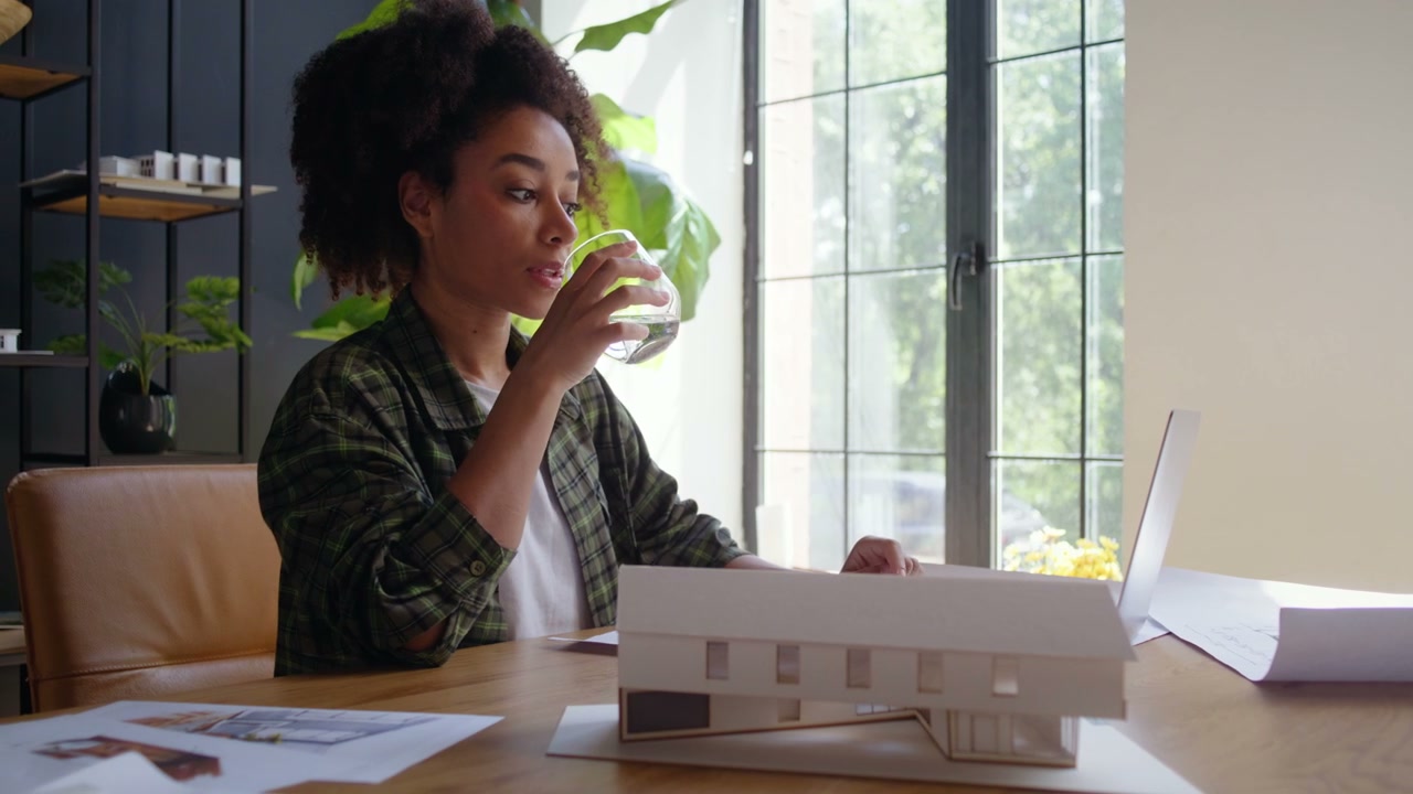 Female Architect Working on House Model
