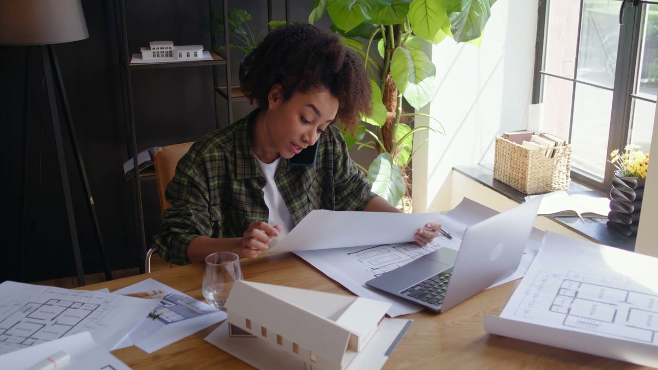 Female Architect Working on Blueprints