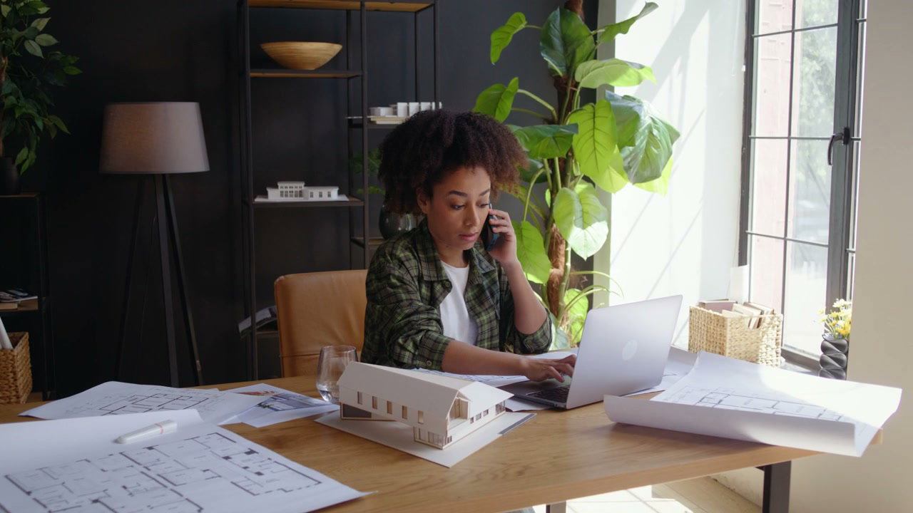 Architect Talking on Phone at Desk