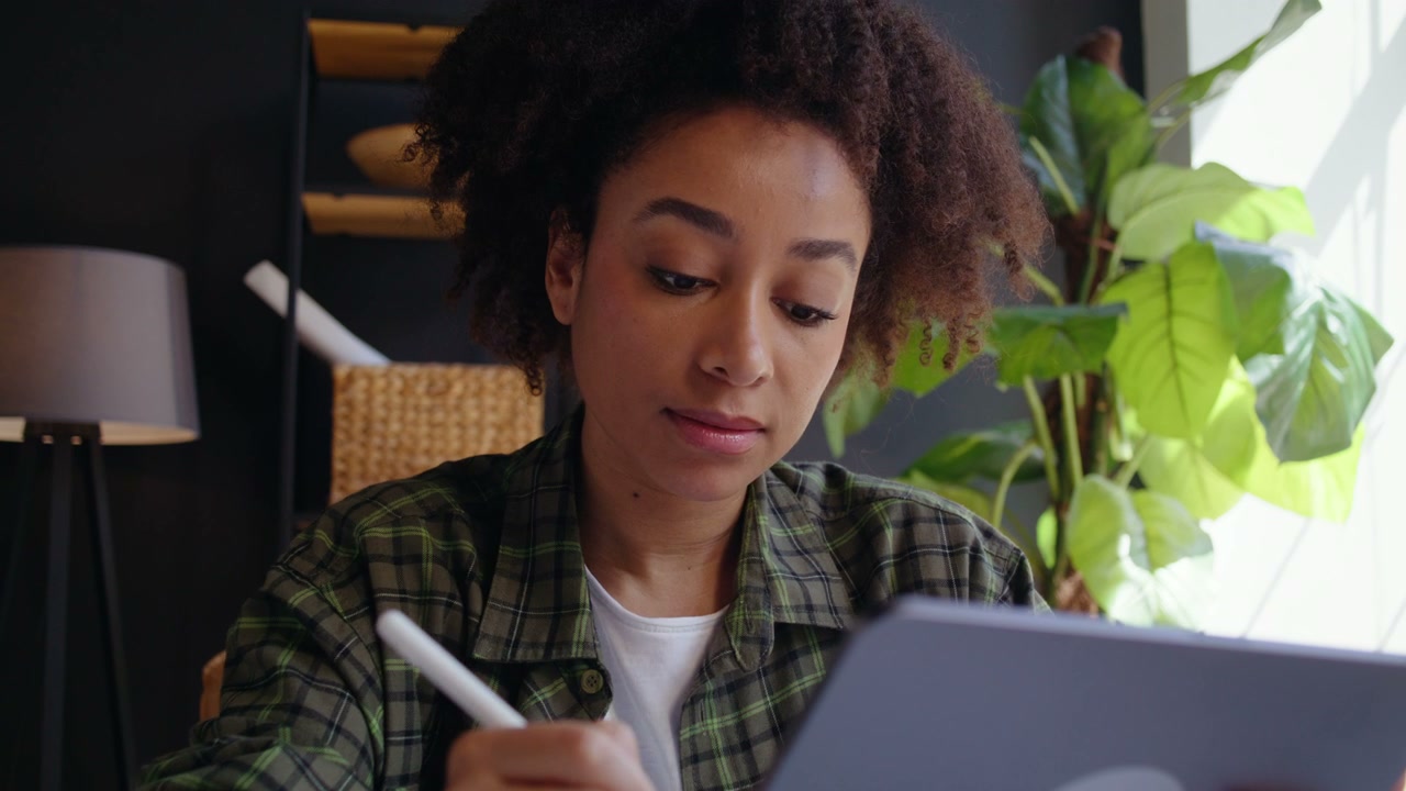 Young Woman Working On Tablet With Stylus