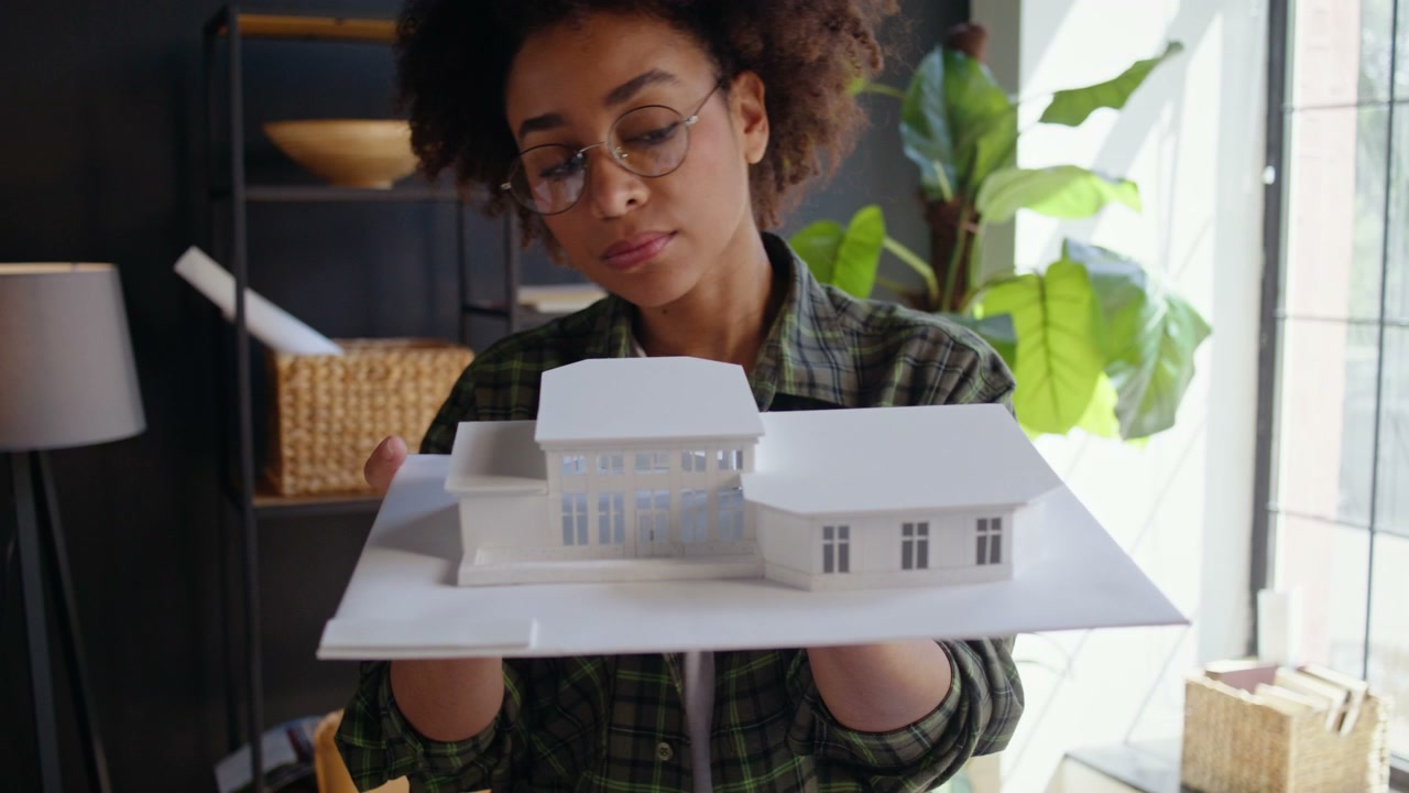 Young Architect Inspecting House Model