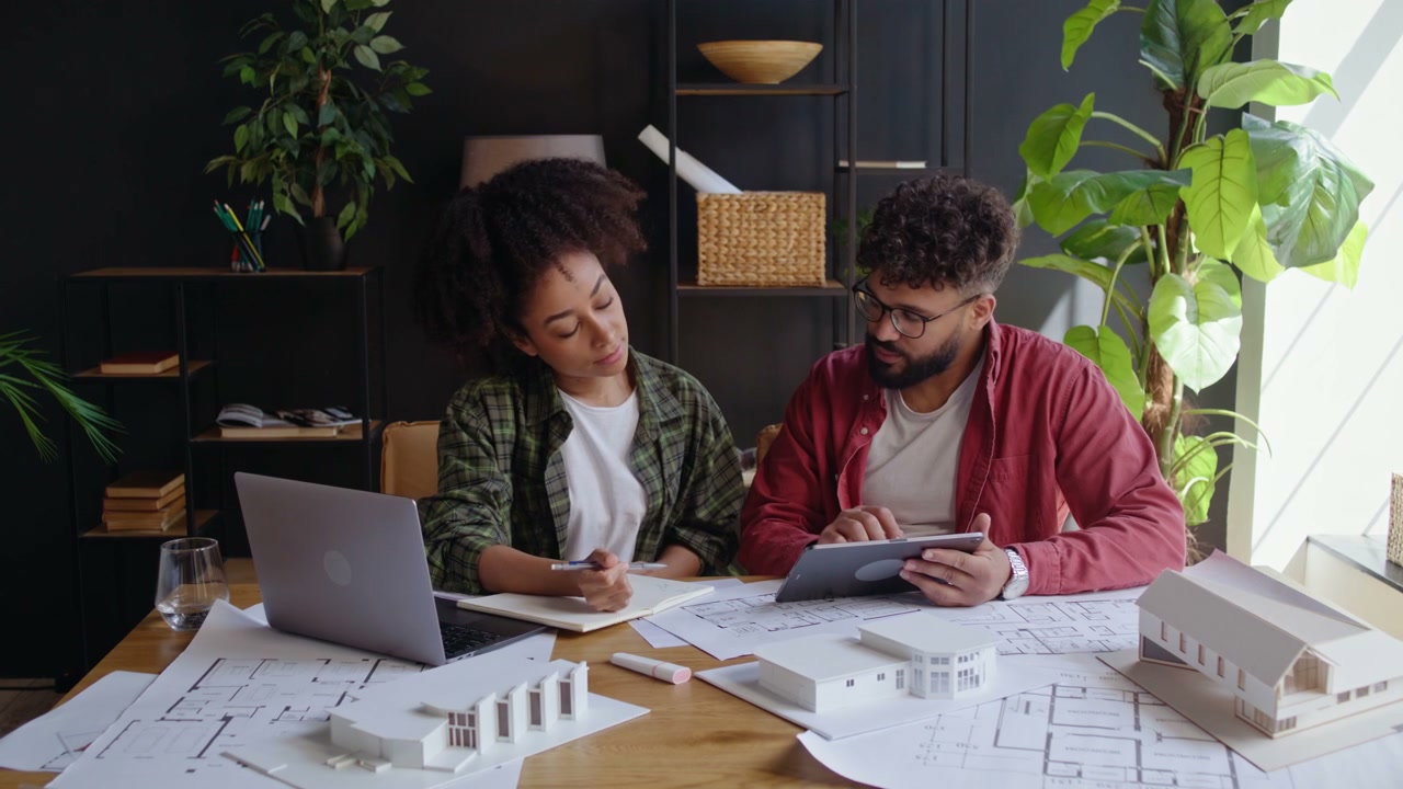 Architects Working on House Blueprints
