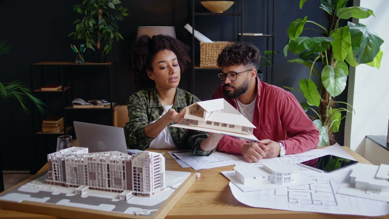 Two Architects Discussing House Model