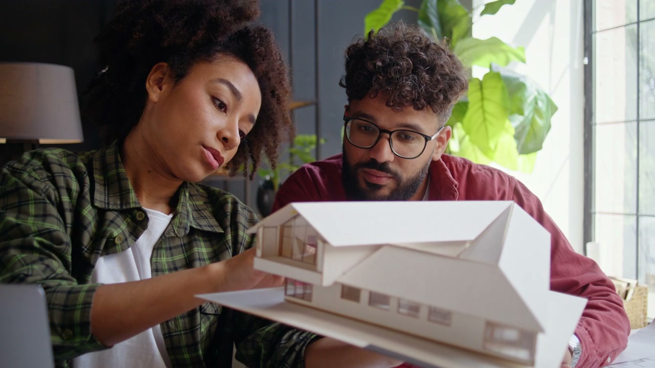 Two Architects Discussing House Model