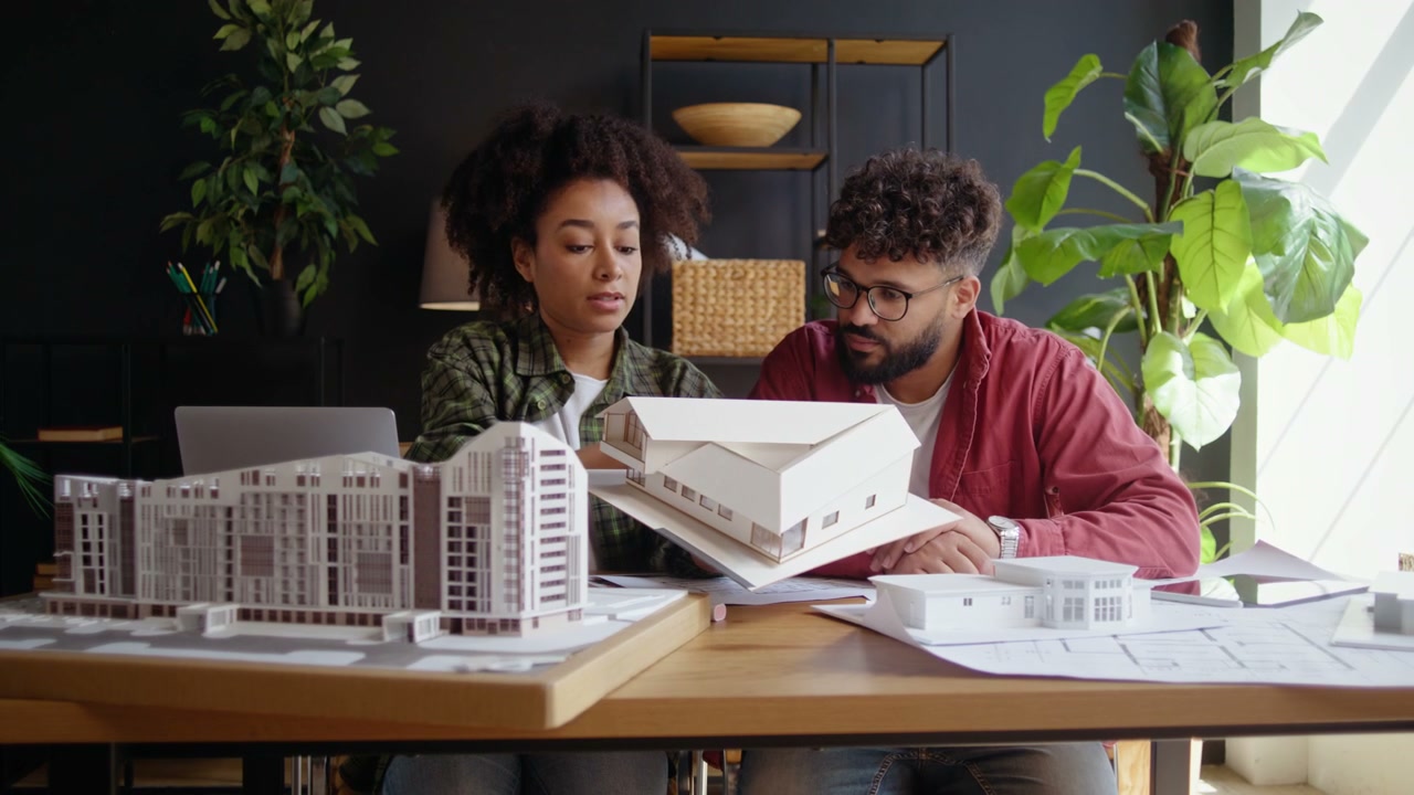 Two Architects Discussing Architectural Models