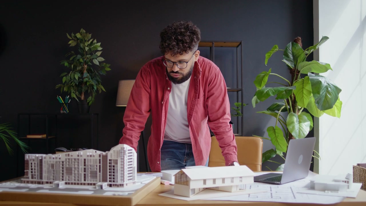 Architect Works on Building Models in Office