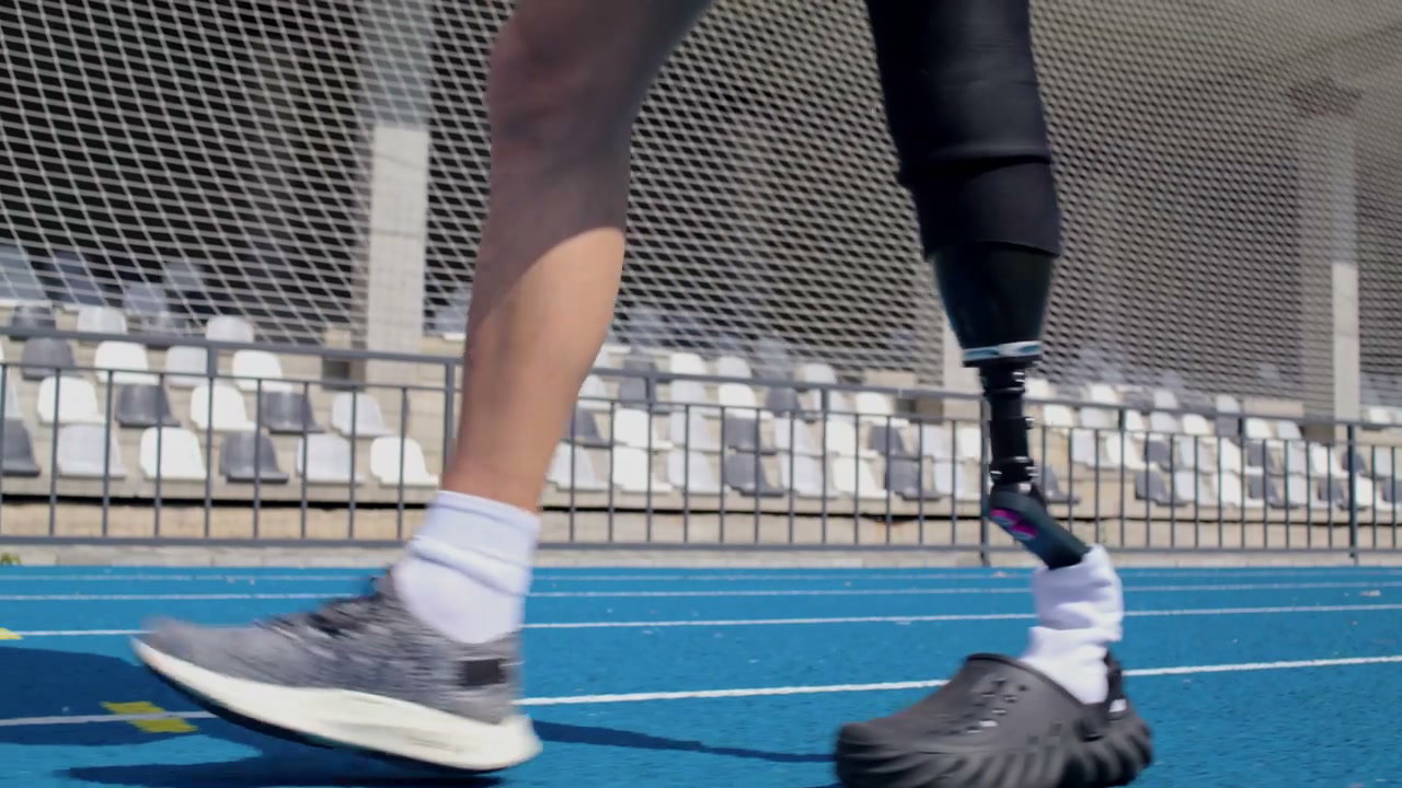 Person with Prosthetic Leg Walking on Track