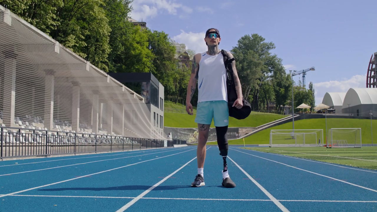 Athlete with Prosthetic Leg on Running Track