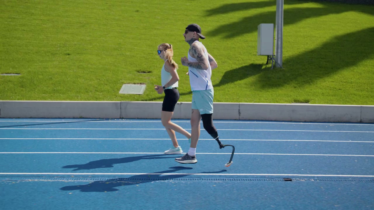 Man with Prosthetic Leg Runs with Woman