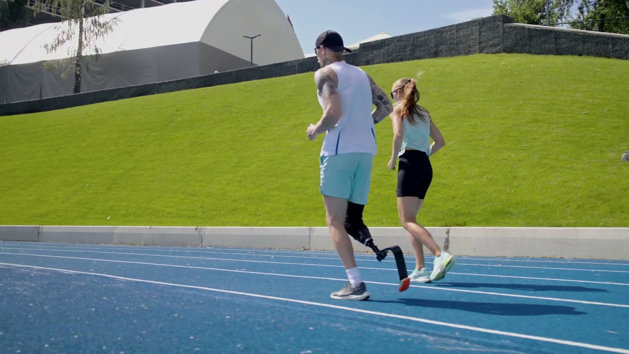 Man with Prosthetic Leg Running on Track