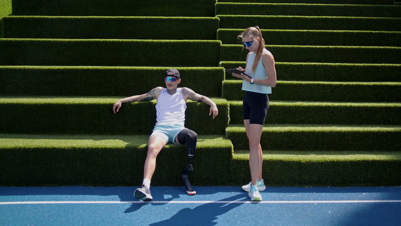 Amputee Athlete Resting with Coach