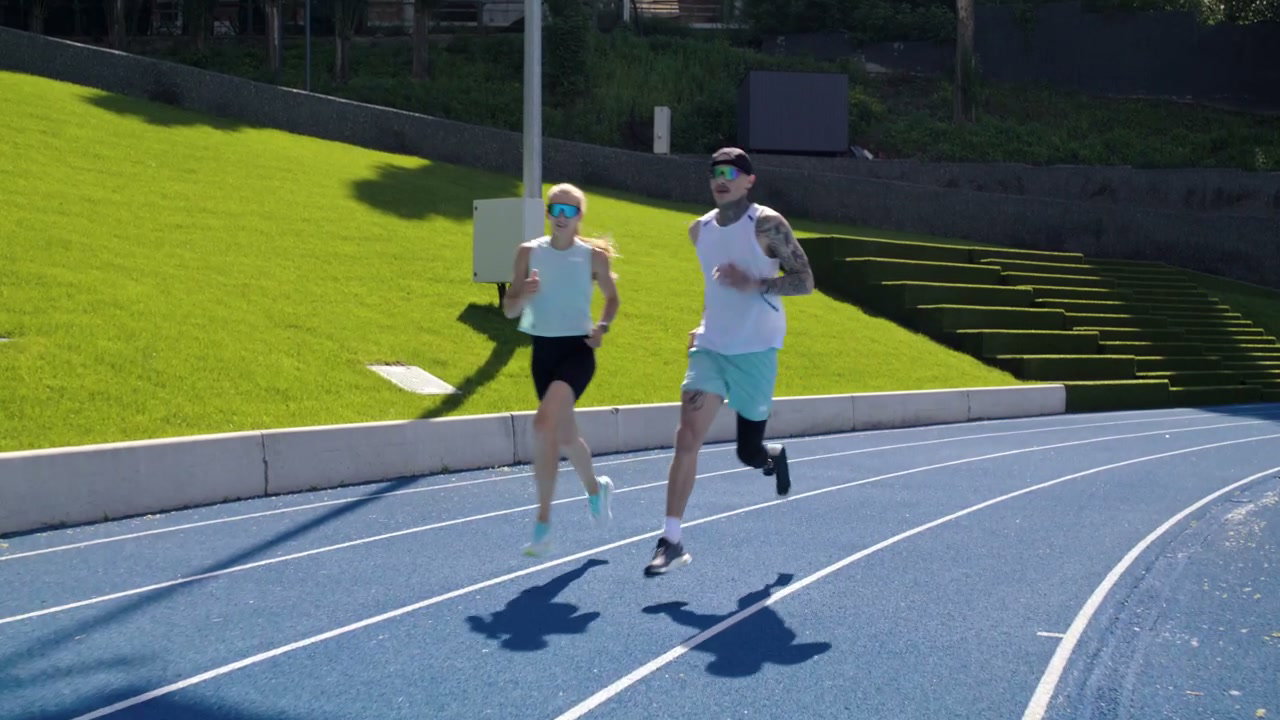 Woman and Man with Prosthesis Running
