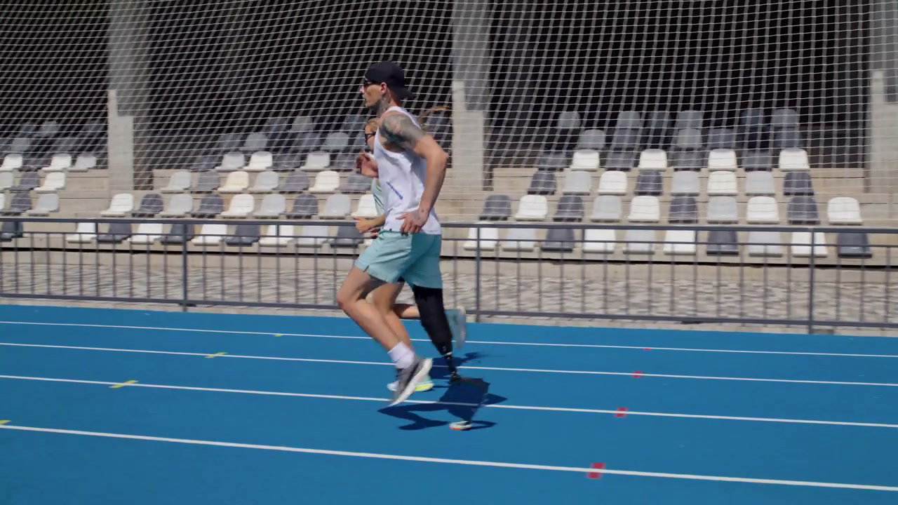Amputee Runner with Woman on Sports Track