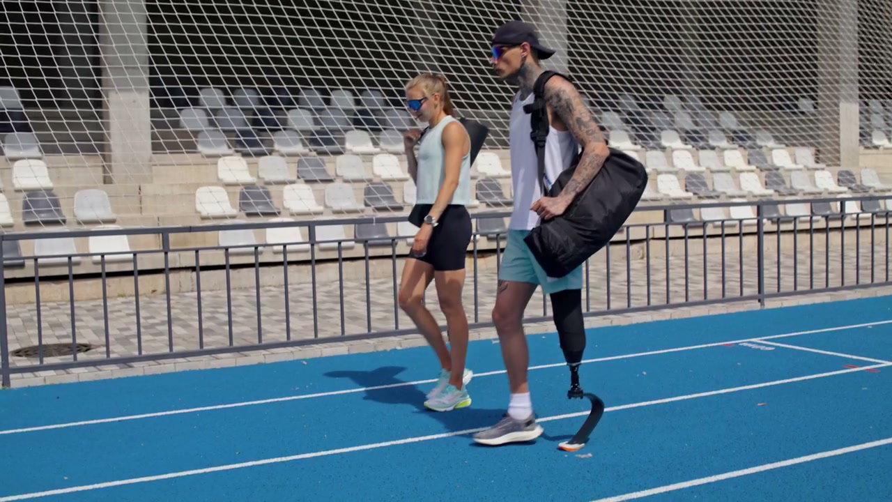 Man with Prosthetic Leg Walking with Woman