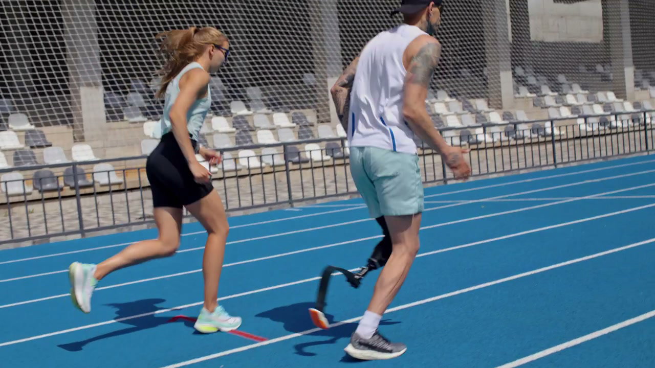Prosthetic Runner and Woman Training on Track