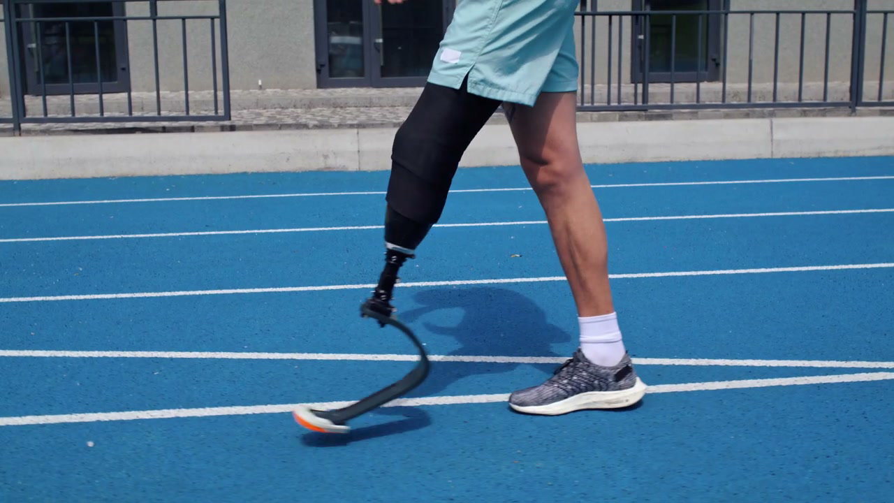 Person with Prosthetic Leg Walking on Track