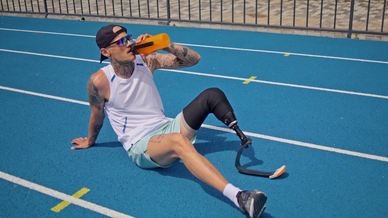 Athlete With Prosthesis Drinking Water