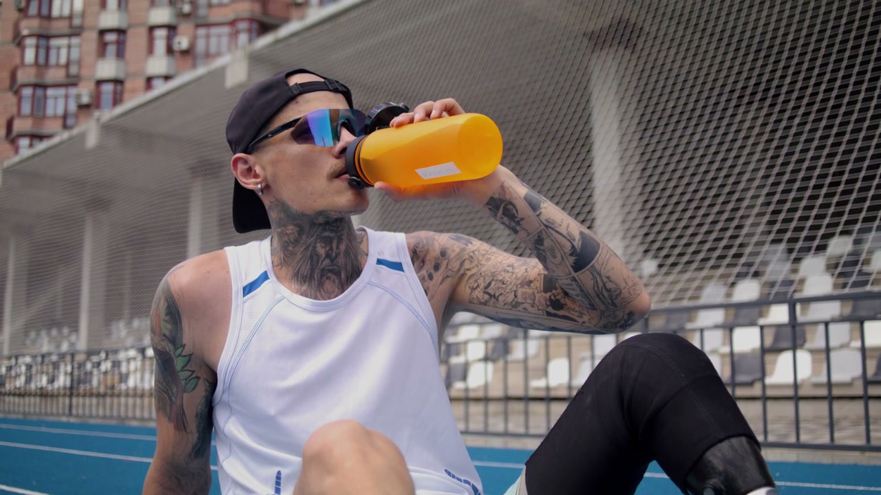 Athlete With Prosthetic Leg Drinks Water