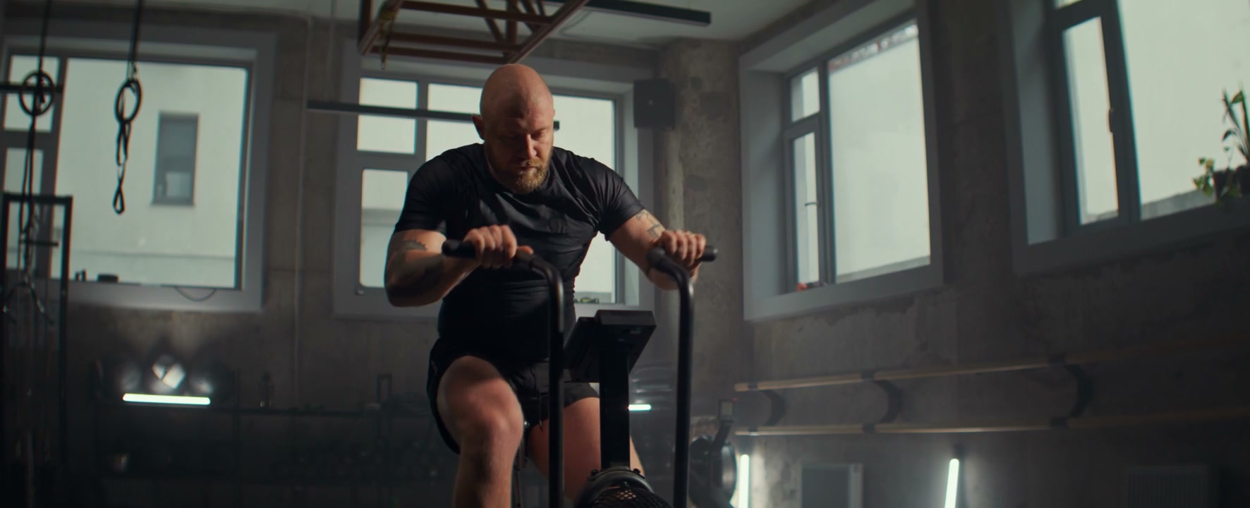 Man Working Out on Air Bike in Gym