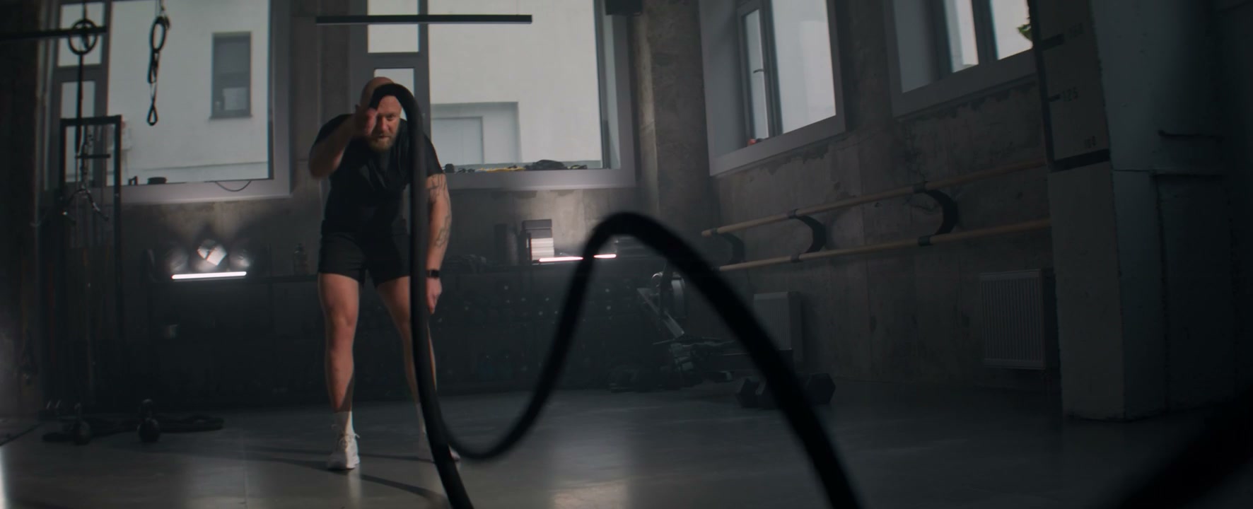 Man Training With Battle Ropes in Gym