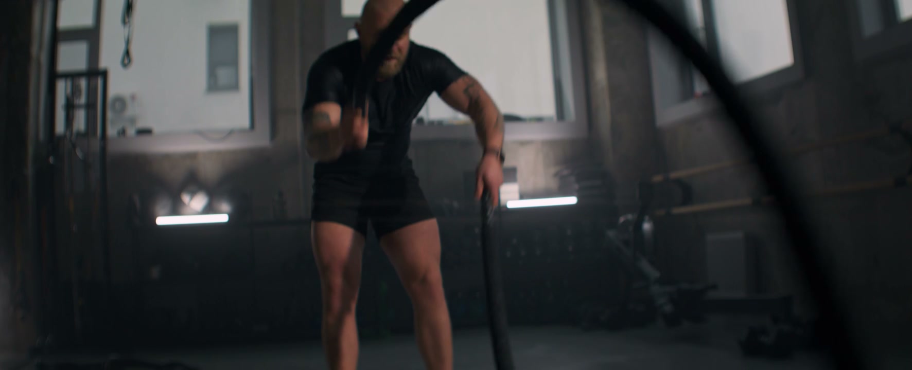Athletic Man Performs Battle Rope Workout