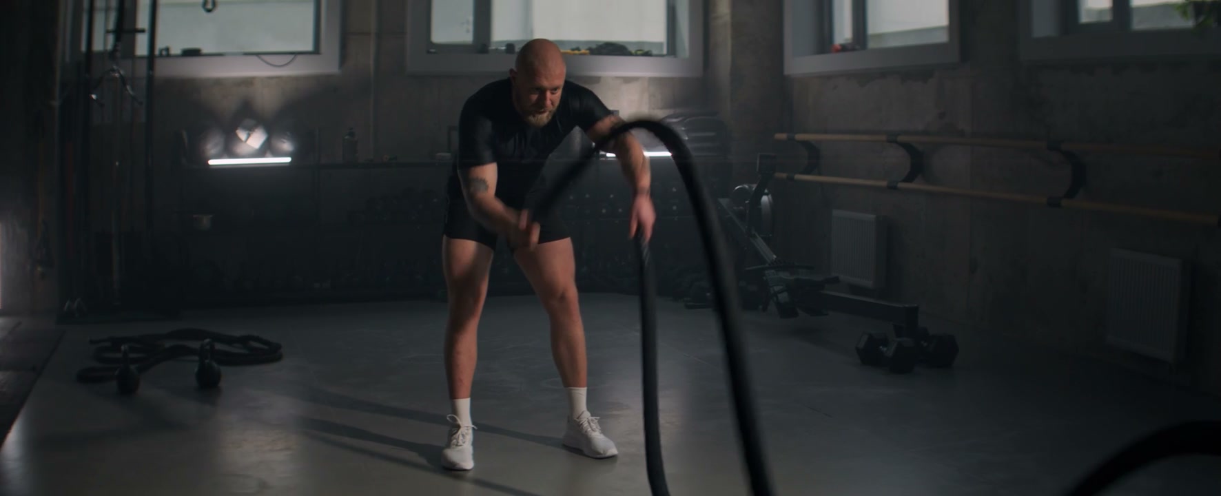 Man Doing Battle Rope Exercise in Gym