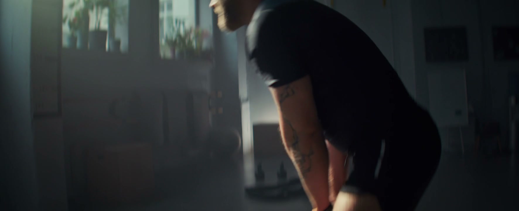 Man Doing Kettlebell Swings in a Gym