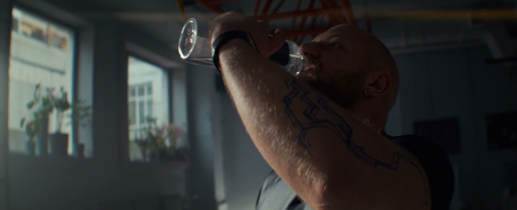 Muscular Man Hydrates After Workout