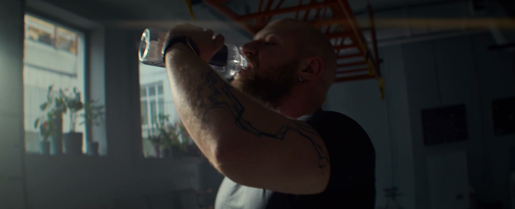 Athlete Drinking Water in Gym