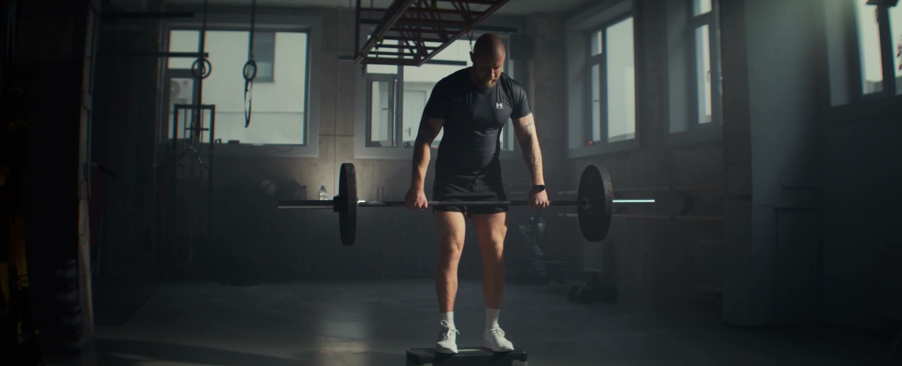 Man Doing Barbell Rows in Gym