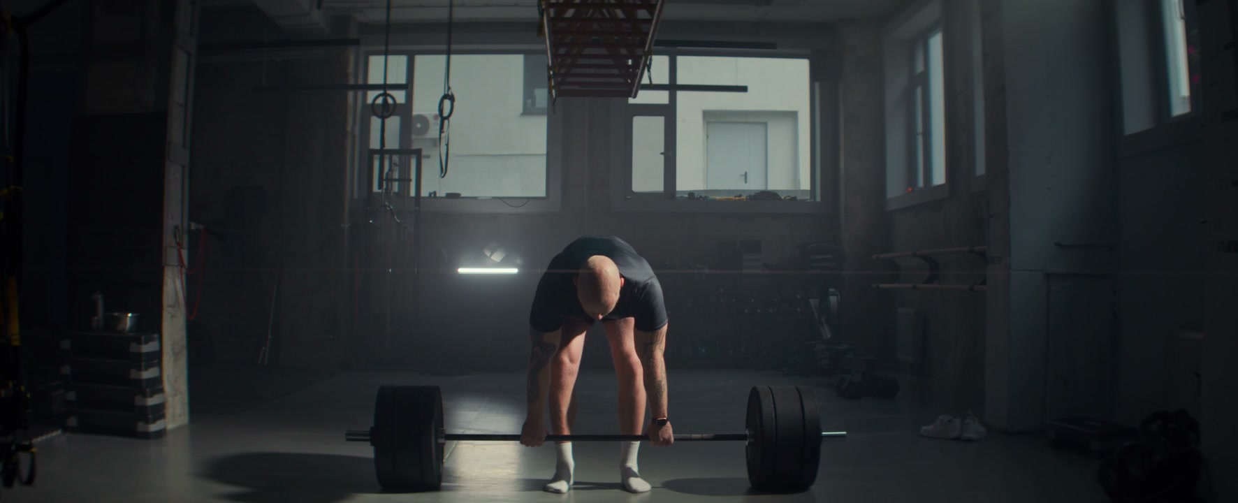 Muscular Man Deadlifting in Gym