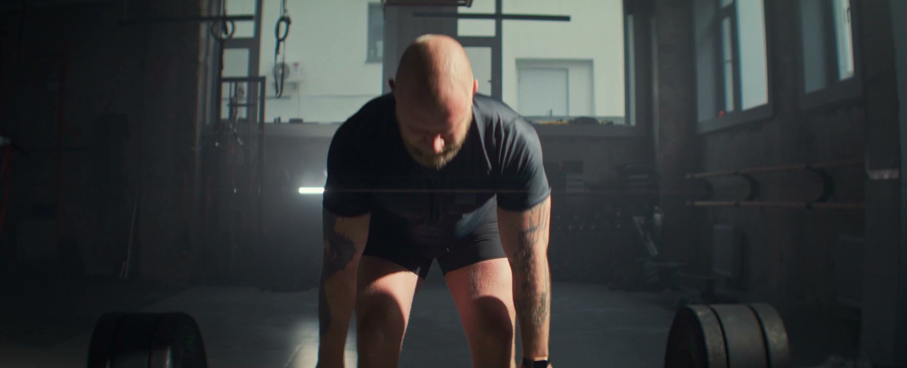 Strong Man Deadlifting Heavy Barbell in Gym