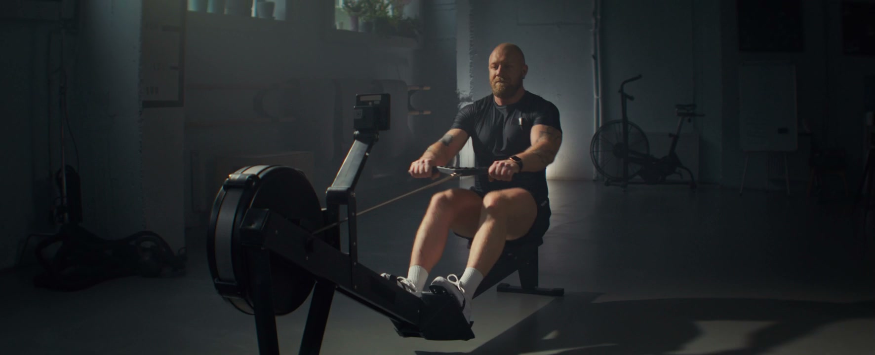 Man Training on Rowing Machine