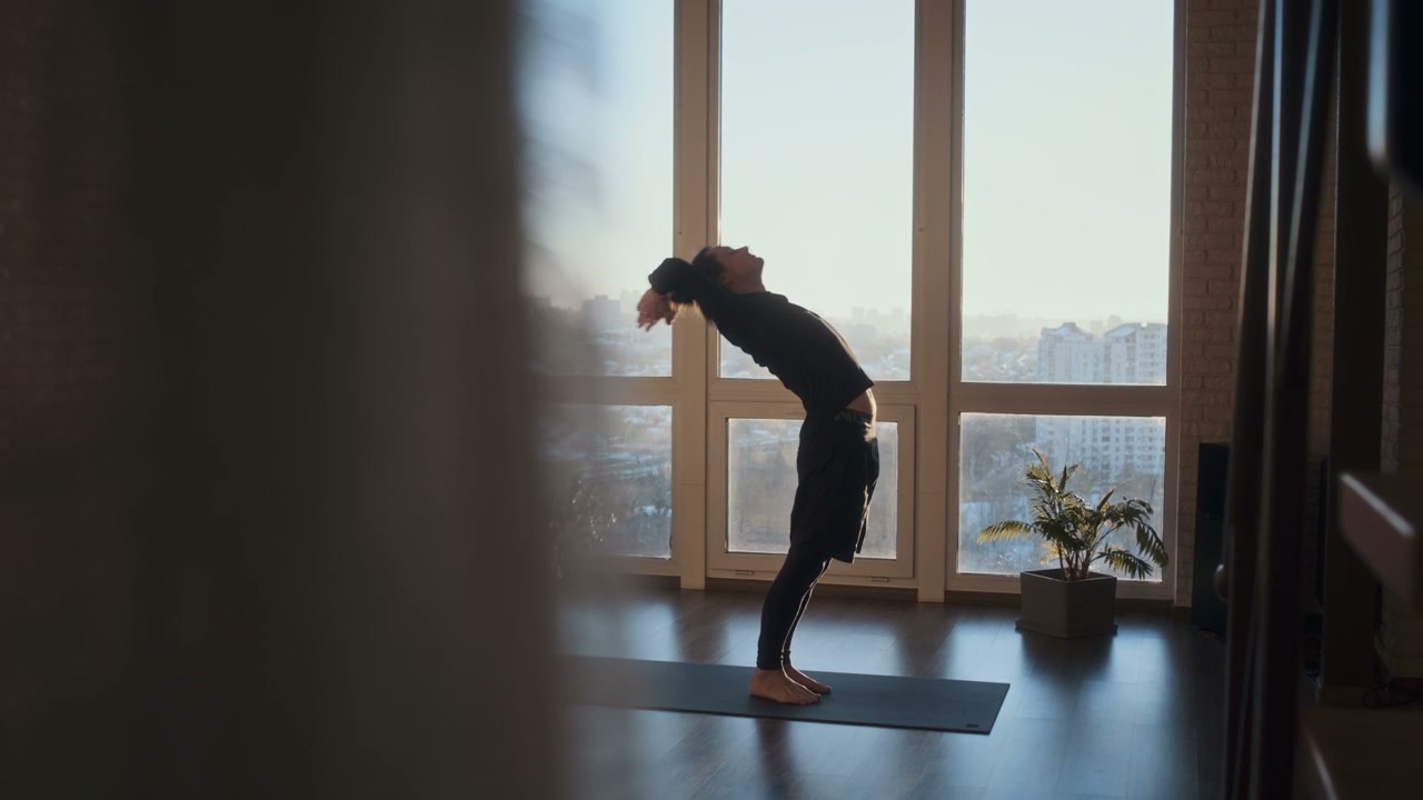 Man Performing Yoga in Bright Studio