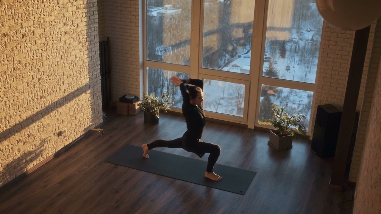 Man Practicing Yoga Poses in Sunny Studio