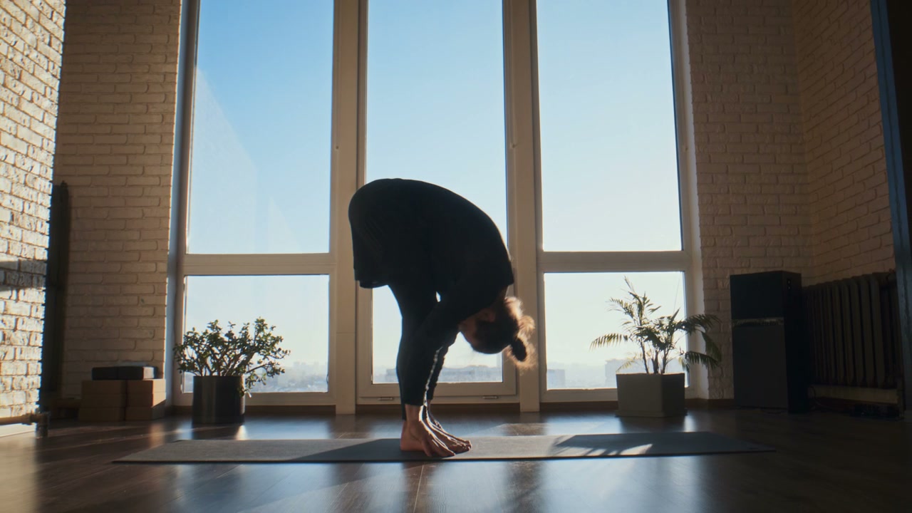 Person Practicing Yoga in Bright Studio