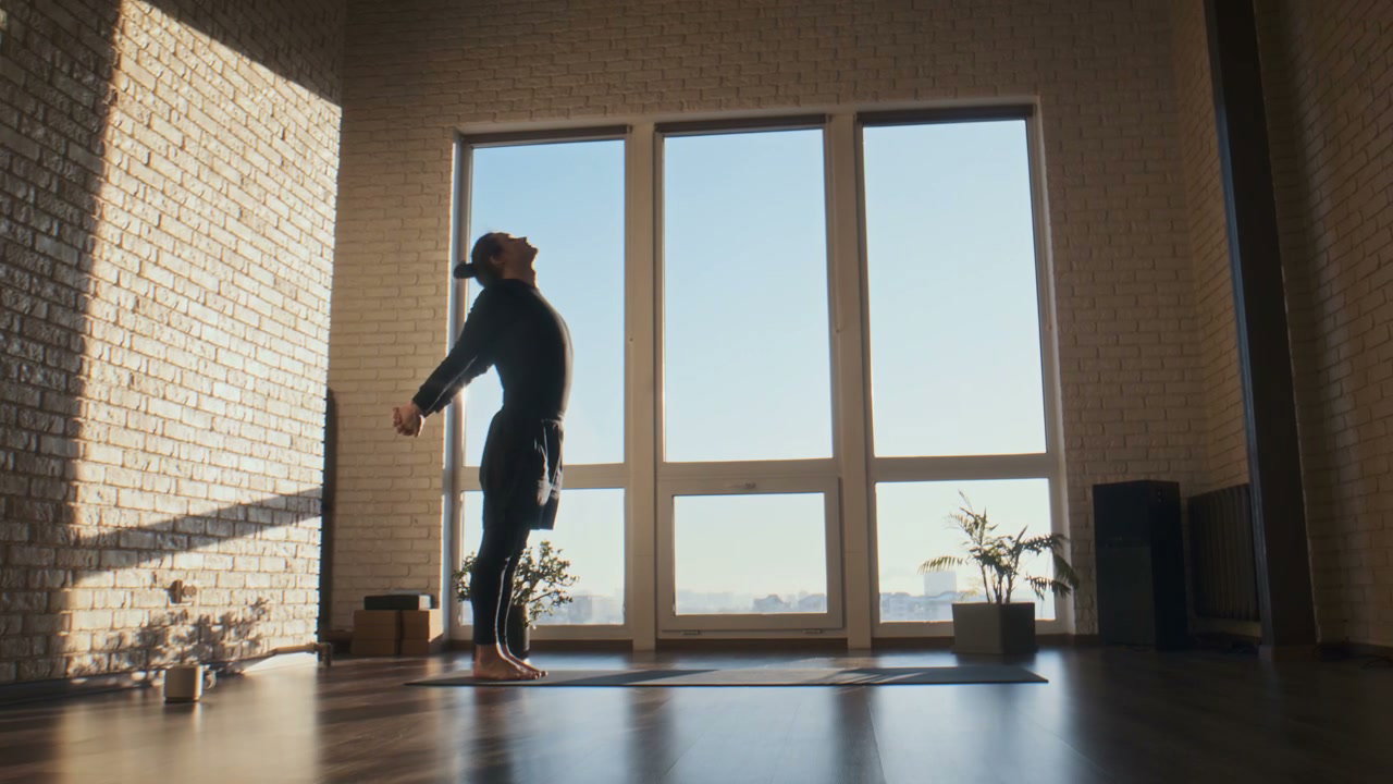 Man Practicing Yoga Sun Salutations in Studio