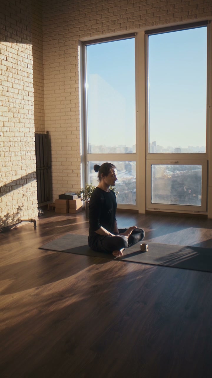 Person Meditating in Yoga Studio