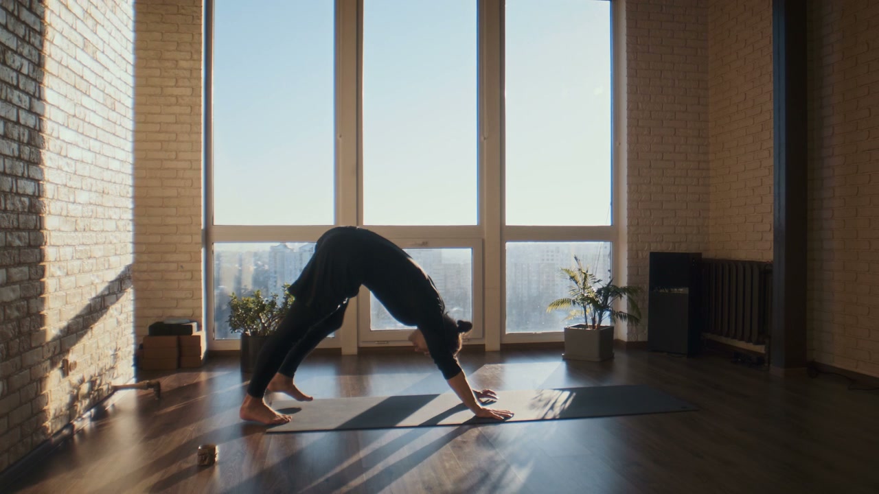 Man Practices Yoga Poses