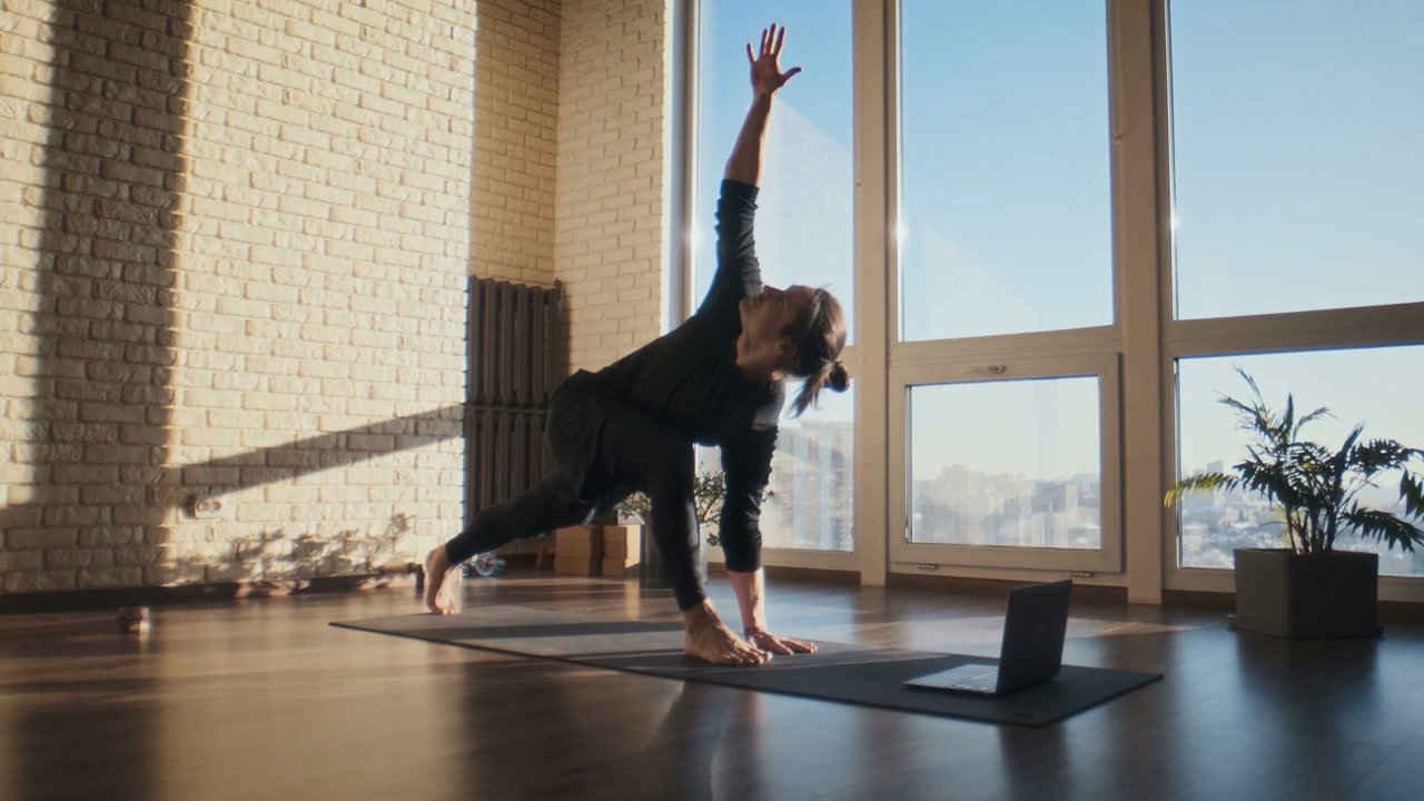 Man Practices Yoga Online in Sunny Studio