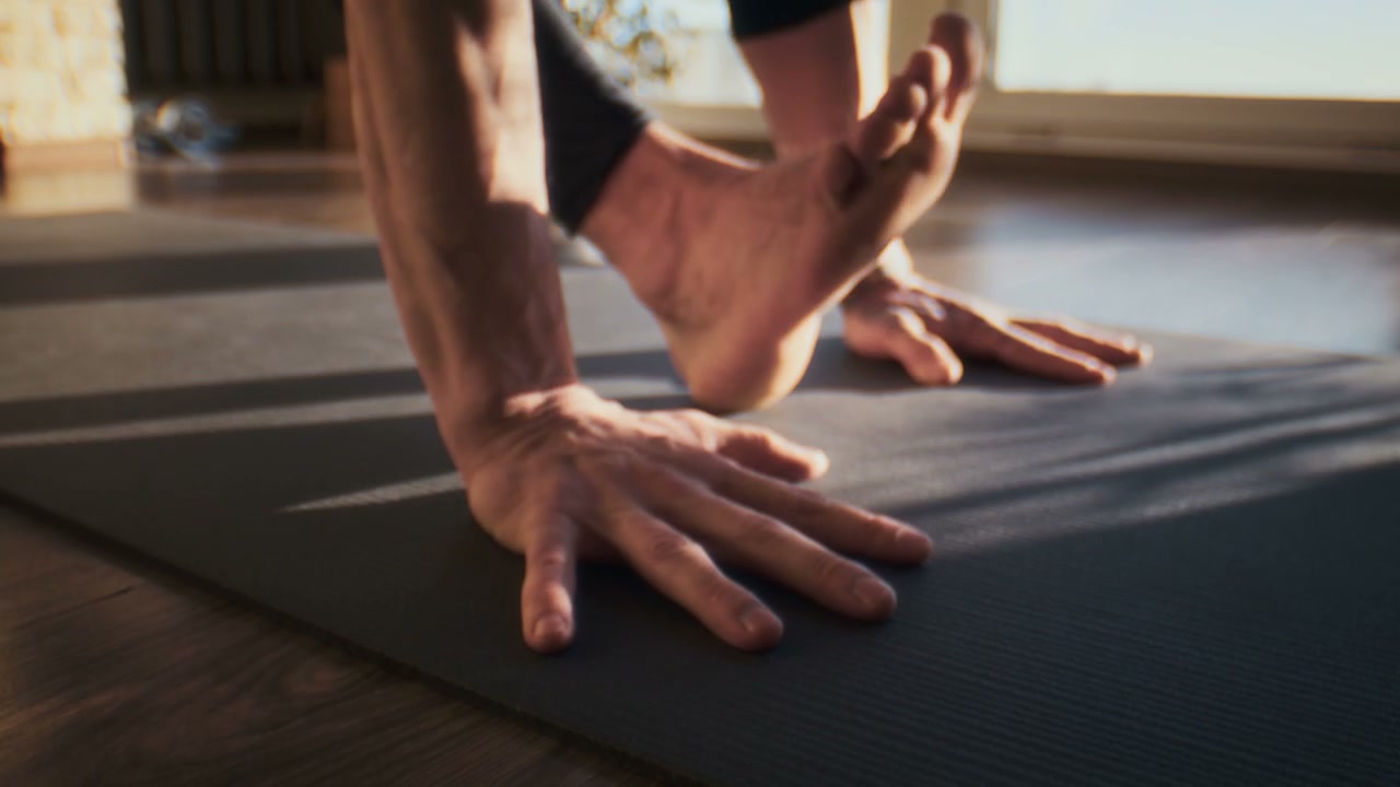Person Practicing Yoga on Mat